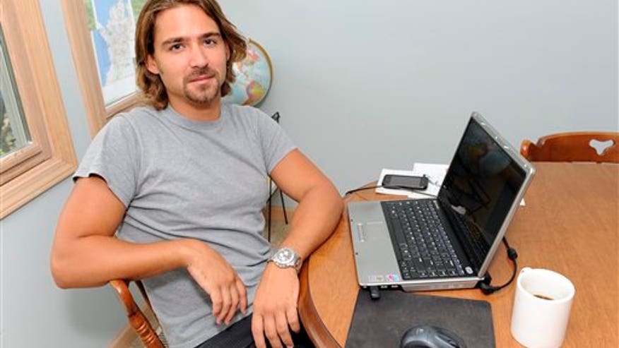 Underemployed man sits at computer